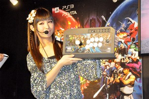 Here's a picture of a nice lady holding one of Hori's new Ultimate Marvel Vs Capcom 3 branded arcade sticks.