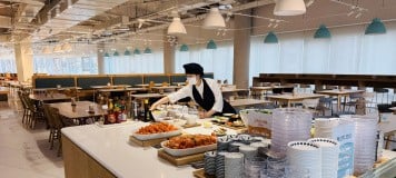 A waitress serving food in Pearl Abyss' dining area